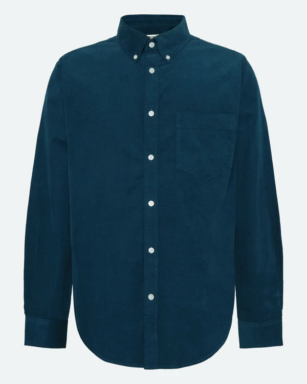 Blue, collared, button up shirt with noticeably contrasting white buttons at the corners of the collar and down the shirt